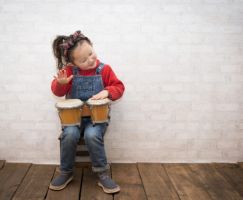 Little girl playing bongo